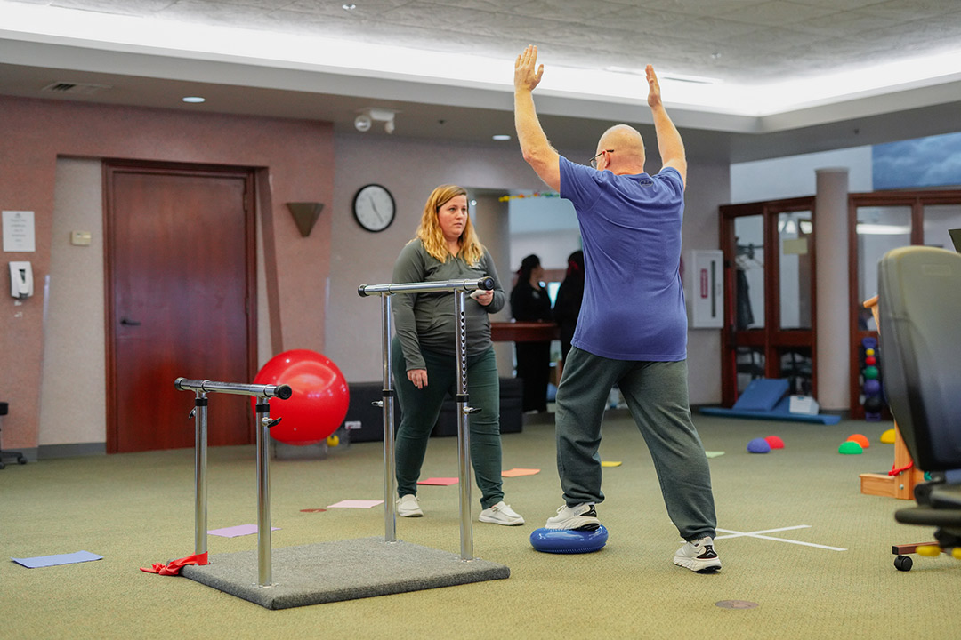 An OID specialist leading a patient through physical therapy